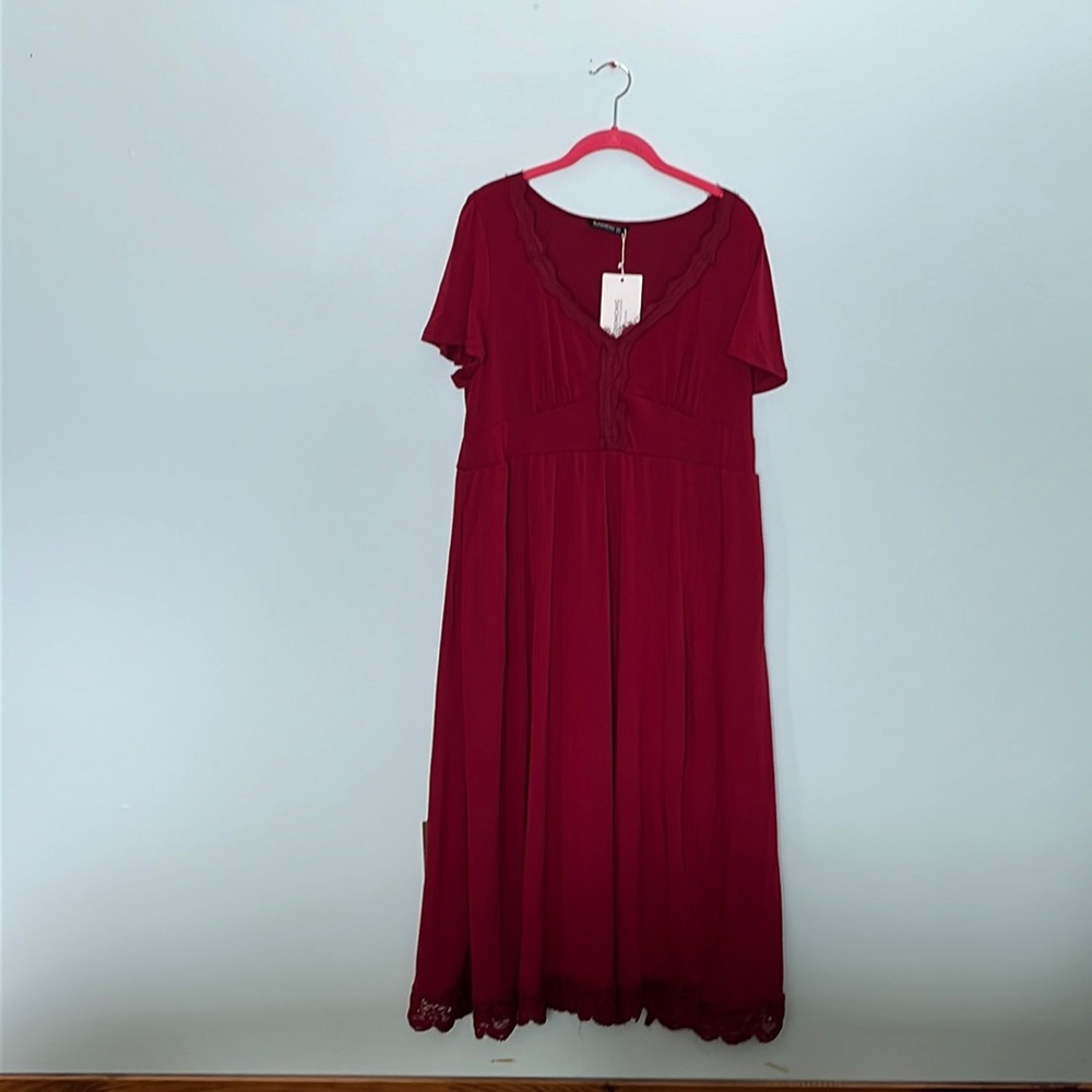 NWT. Deep burgundy dress from Bloomchic. Size 10. Lace V-neck & hem. Pockets.